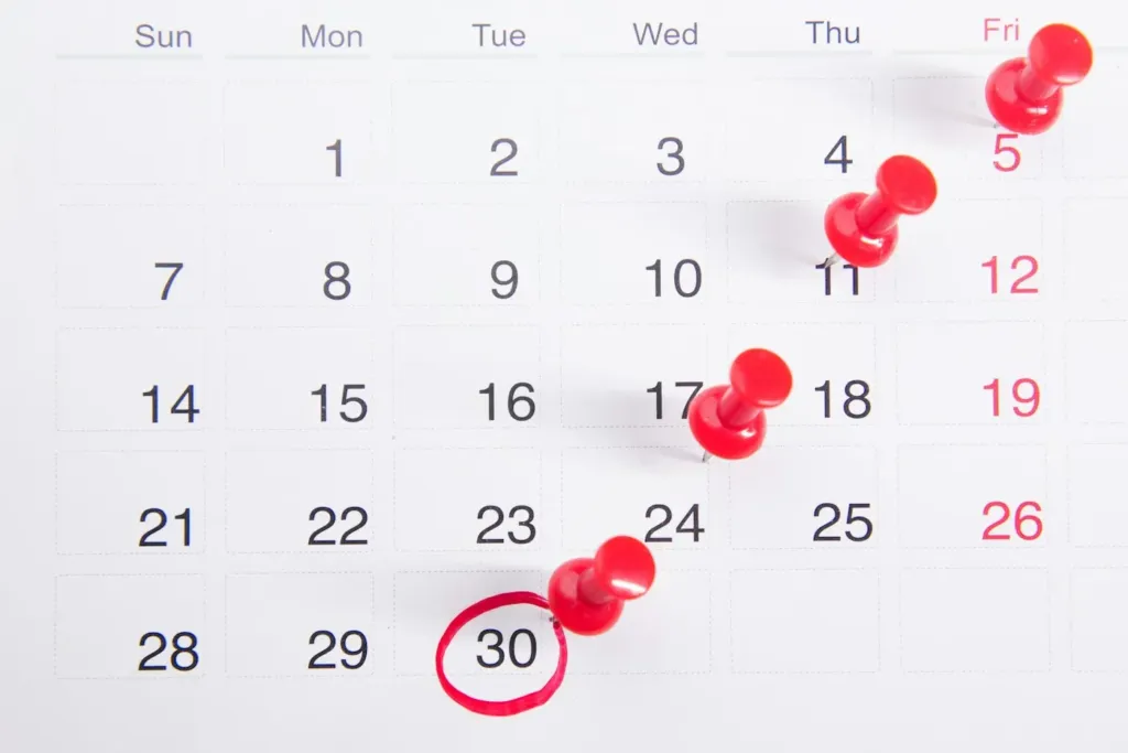 Calendar with red pins marking deadlines